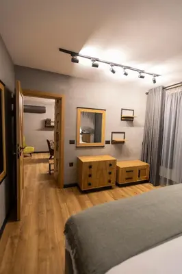 a bedroom with a bed and a dresser and a mirror at Villa Sintica in Sandanski