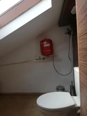 a bathroom with a toilet and a red fire hydrant at Guest Room Asparuh in Troyan