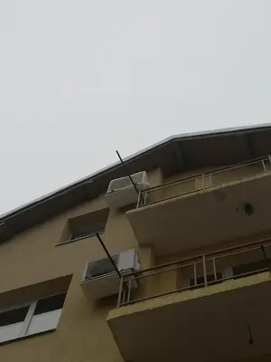 a building with two balconies on the side of it at Guest Room Asparuh in Troyan