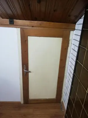 two doors in a room with wooden ceilings at Guest Room Asparuh in Troyan