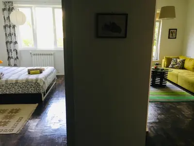 a living room with a bed and a couch at Sweet home in the heart of Sofia in Sofia