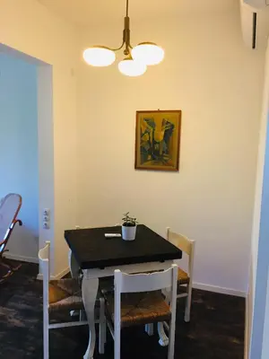 a dining room with a black table and chairs at Sweet home in the heart of Sofia in Sofia