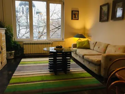 a living room with a couch and a table at Sweet home in the heart of Sofia in Sofia