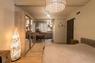 a bedroom with a bed and a living room at Este Apart - Top center in Sofia