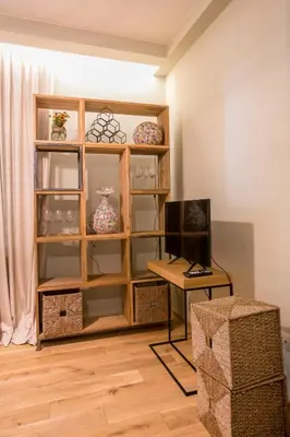 a room with a book shelf with vases and a table at Este Apart - Top center in Sofia