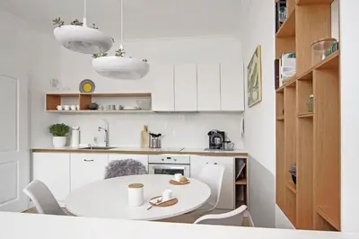 a white kitchen with a white table and chairs at Hip, Cosmopolitan Gem in the Heart of Sofia by Flat Mаnager in Sofia