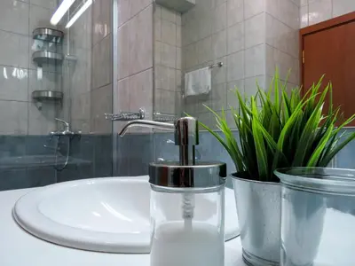 a bathroom sink with a faucet on a counter at Rivendell Apartments Flora Complex in Borovets