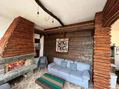 a living room with a couch and a fireplace at Guest house Legeto in Samokov