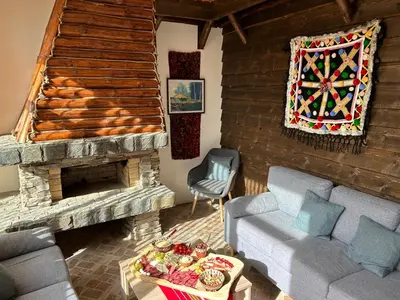 a living room with a couch and a fireplace at Guest house Legeto in Samokov
