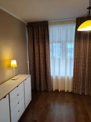 a room with a desk and a window with curtains at Mladost 1 Apartment near the metro in Sofia