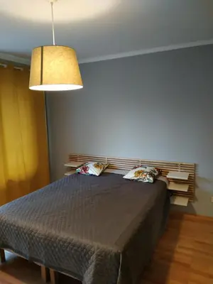 a bedroom with a large bed with a lamp at Dolce Vita-Sofia Apartment in Sofia