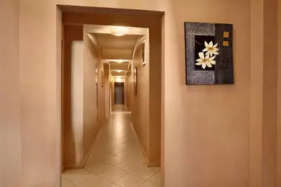 a hallway with a picture of a flower on the wall at Family Hotel Marsina in Sofia