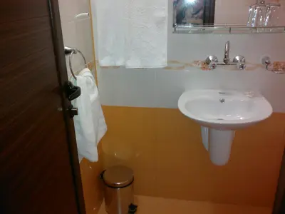 a bathroom with a sink and a toilet at Family Hotel Marsina in Sofia
