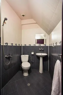a bathroom with a toilet and a sink at Family Hotel Marsina in Sofia
