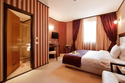 a hotel room with a bed and a bathroom at Best Western Plus Bristol Hotel in Sofia