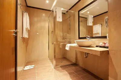 a bathroom with a sink and a glass shower at Best Western Plus Bristol Hotel in Sofia