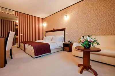 a hotel room with a bed and a table at Best Western Plus Bristol Hotel in Sofia