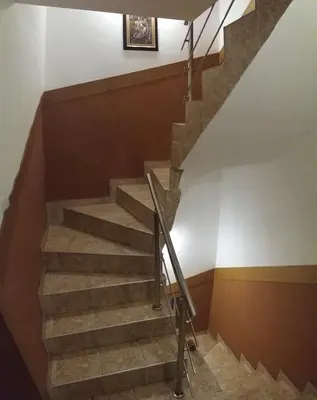a staircase in a building with a picture on the wall at Comfort Guest House in Samokov
