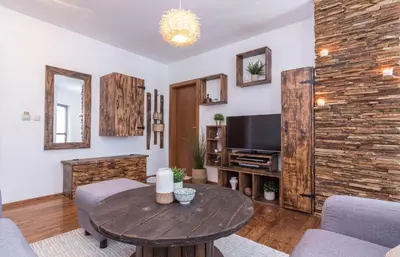 a living room with a wooden table and a tv at ★ Chic & Elegant 1 Bedroom in Eagle's Nest Complex ★ Close to Gondola and Bar Street in Bansko