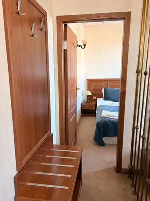 a room with a bedroom with a bed and a door at private apartments Emerald in Bansko