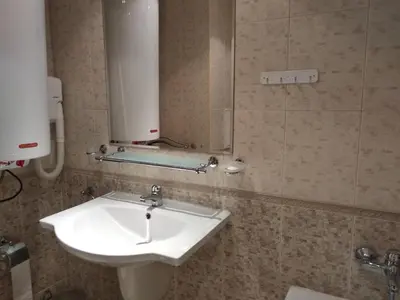 a bathroom with a white sink and a mirror at private apartments Emerald in Bansko