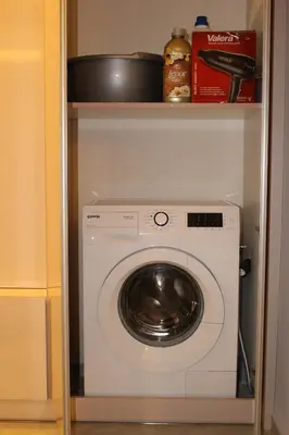 a white washer and dryer in a closet at Kapana Luxury City Center Apartments with Garage in Plovdiv