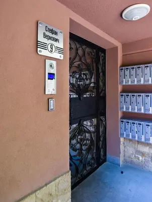 a entrance to a building with a sign on a door at Kapana Luxury City Center Apartments with Garage in Plovdiv