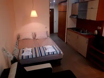 a small bedroom with a bed with towels on it at Studio Villa Park 119 in Borovets