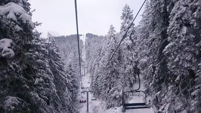 a ski lift in the snow next to some trees at Studio Villa Park 119 in Borovets