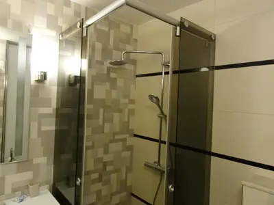 a shower with a glass door in a bathroom at Apartment Sofia Center 2 in Sofia