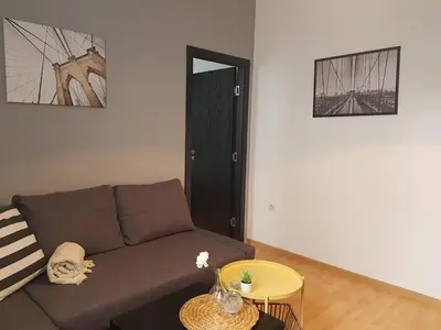 a living room with a couch and a table at Radomir Downtown Apartments in Radomir
