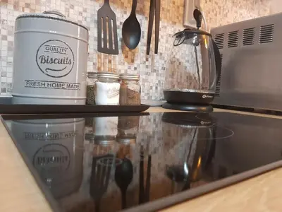 a kitchen counter with a coffee pot and utensils at Radomir Downtown Apartments in Radomir