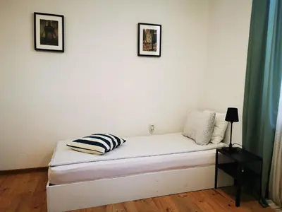 a bed in a room with two pictures on the wall at Radomir Downtown Apartments in Radomir