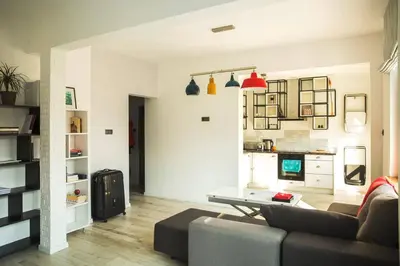 a living room with a couch and a table at Sunny studio on ulica Lyuben Karavelov in Sofia