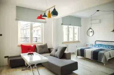 a living room with a couch and a bed at Sunny studio on ulica Lyuben Karavelov in Sofia