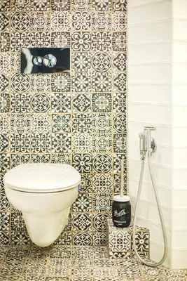 a bathroom with a toilet and a tiled wall at Sunny studio on ulica Lyuben Karavelov in Sofia