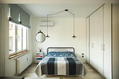 a bedroom with a bed with a striped blanket at Sunny studio on ulica Lyuben Karavelov in Sofia