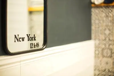 a mirror with a new york dies sign on a window at Sunny studio on ulica Lyuben Karavelov in Sofia