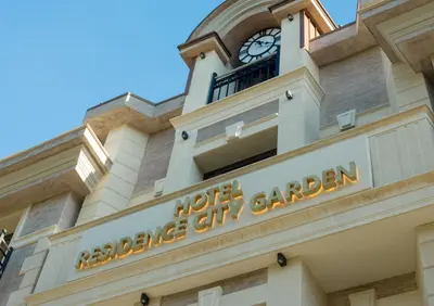 a building with a clock tower on top of it at Residence City Garden - Certificate of Excellence Top 10 BEST Five-Stars City Hotels for 2024 awarded by HTIF in Plovdiv