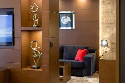 a living room with a couch and a tv at Family Hotel Strannopriemnitza in Oreshak