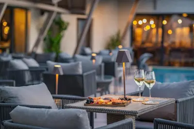 a table with a plate of food and two glasses of wine at Medite Spa Resort and Villas in Sandanski