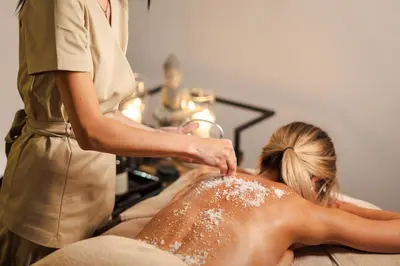 a woman getting a back massage in a salon at Medite Spa Resort and Villas in Sandanski