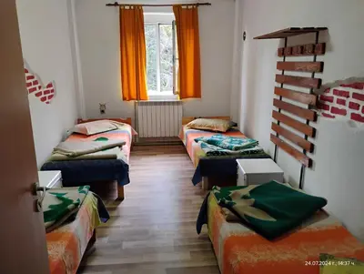 a room with four beds and a window at хижа 