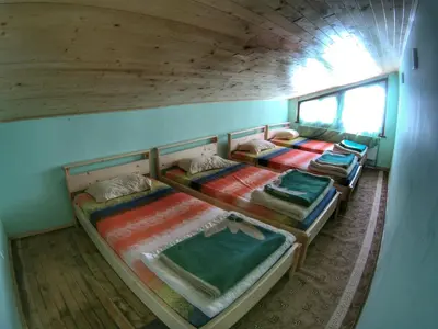 a room with three bunk beds in a house at хижа 