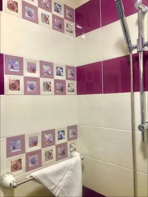 a bathroom with a shower with purple and white tiles at Sofia centre in Sofia