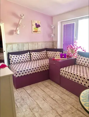 a childs room with a couch and a table at Sofia centre in Sofia