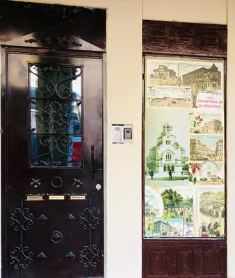 a black door with a window next to a wall at Sofia centre in Sofia