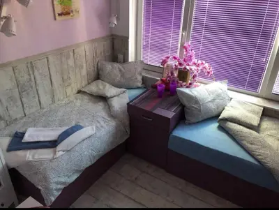 a bedroom with two beds and a table with pillows at Sofia centre in Sofia