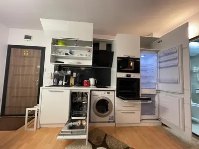 a kitchen with a washing machine and a washer at Borovets Mountain Apartment Sequoia in Borovets