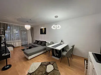 a living room with a couch and a table at Borovets Mountain Apartment Sequoia in Borovets